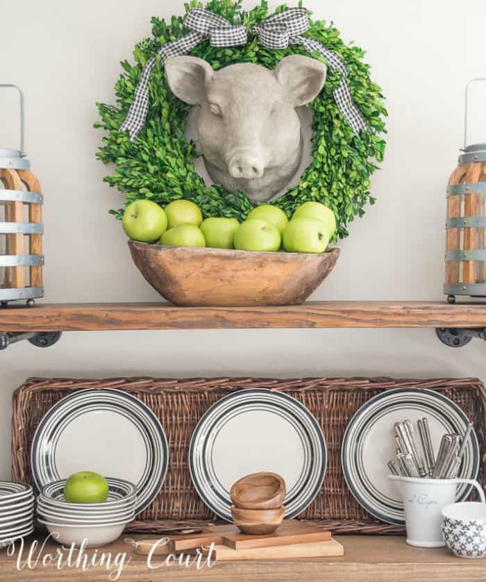 A faux pig head surrounded by a preserved boxwood wreath. #artideas #wallartideas #artworkideas #diyart #artworkdisplay #fauxpighead