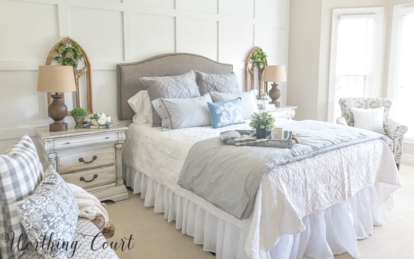 Farmhouse style bedroom with gray upholstered headboard, ticking stripe duvet set, diy painted furniture and gothic arch wall decor #farmhousedecor #cottagedecor #shabbychicdecor #bedroomdecor #decoratingideas #bedroomdecoratingideas