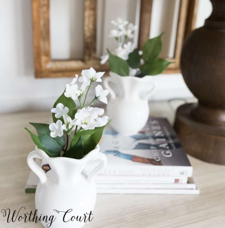 white vases filled with tiny white flowers