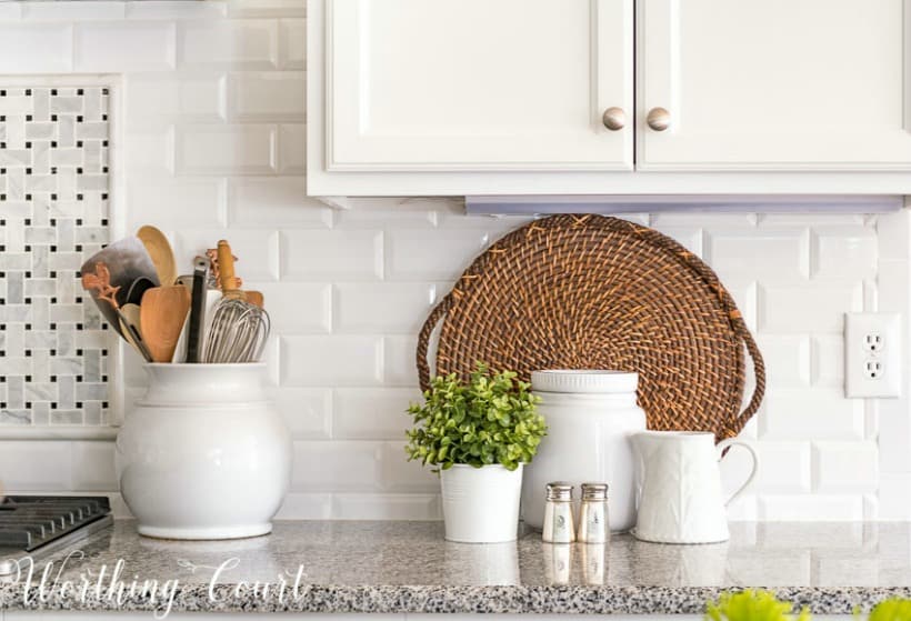 white-beveled-subway-tile-backsplash-with-granite-counters-and-white-kitchen-accessories.