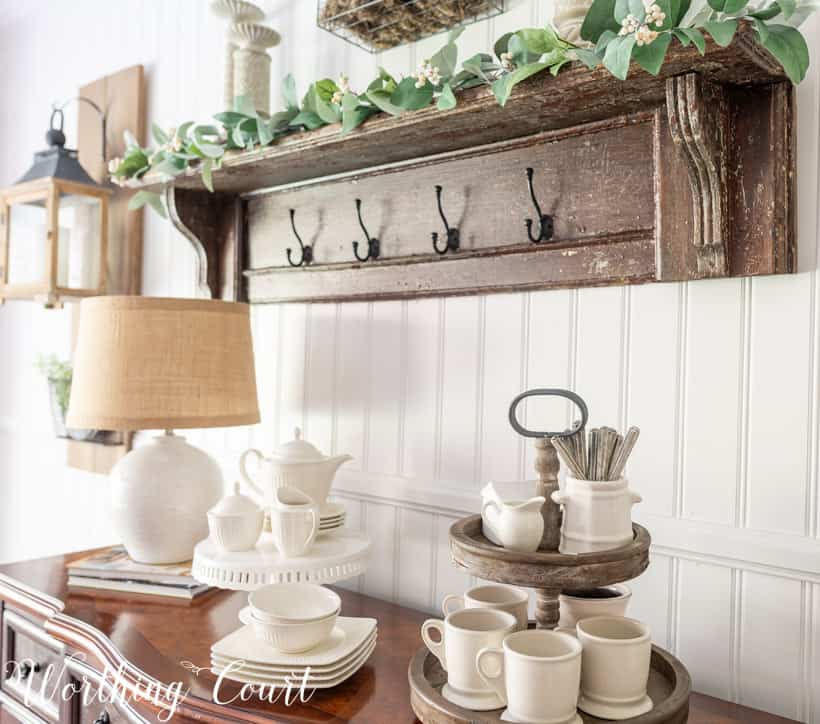 Sideboard with white dishes and a tiered tray.