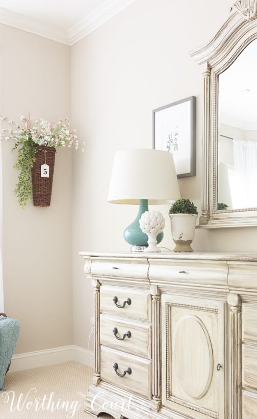 hanging wicker wall basket fill with faux florals and greenery