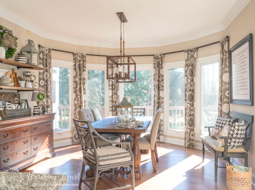 farmhouse style breakfast room with neutral colors and bay window