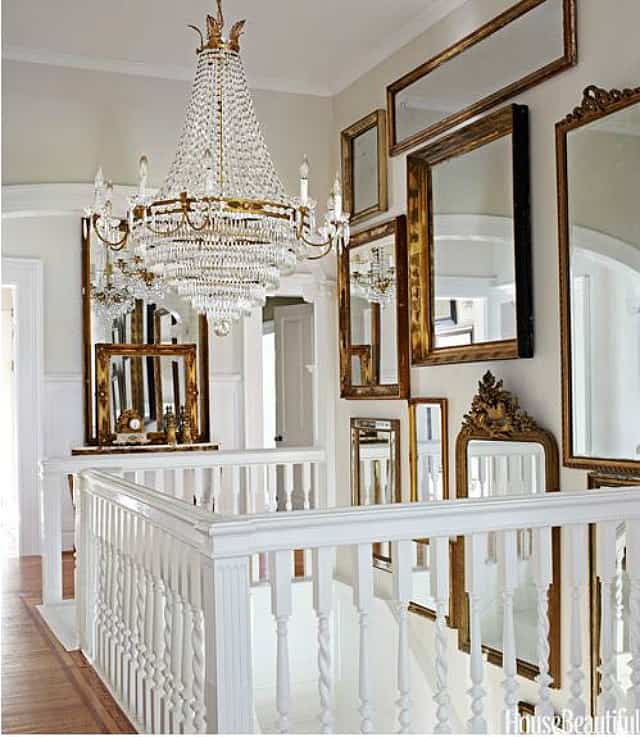 Foyer filled with vintage gold framed mirrors to make it look larger and brighter