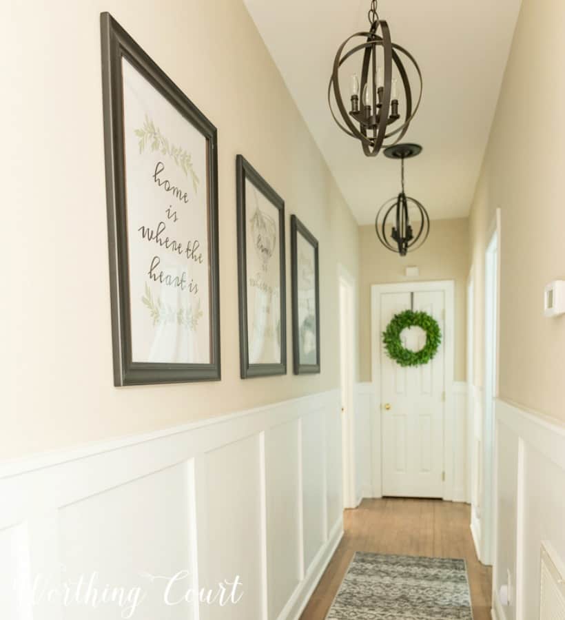 neutral hallways with board and batten walls and pendant lighting