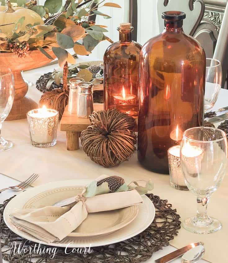 Thanksgiving table using brown glass and neutral dishes and linens