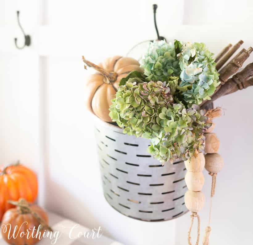 hanging metal bucket filled with fall decorations