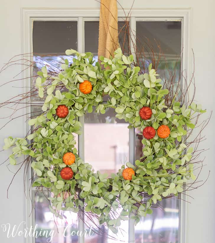 Premade eucalyptus wreath with pumpkins added for fall.