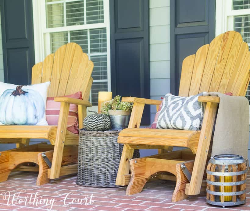 A wicker basket turned into a small table on the porch.