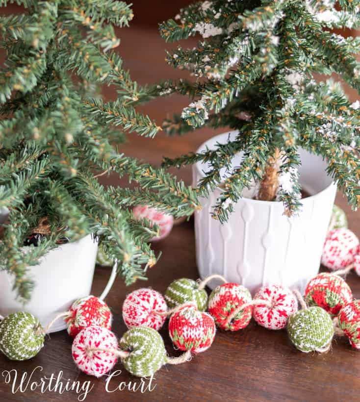 A fabric Christmas Garland of ornaments on the table.