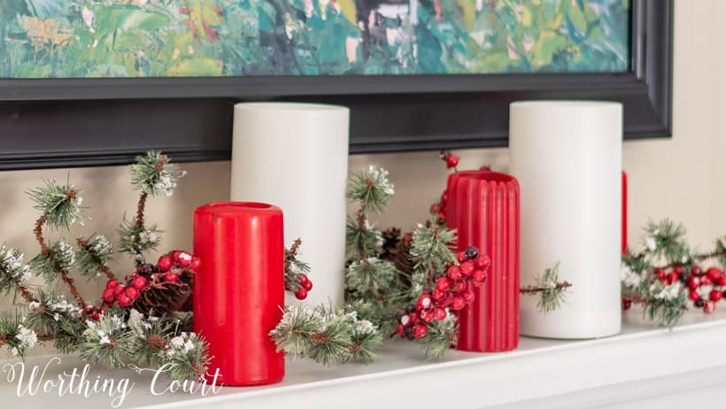 Red and white candle arrangement on the white mantel.