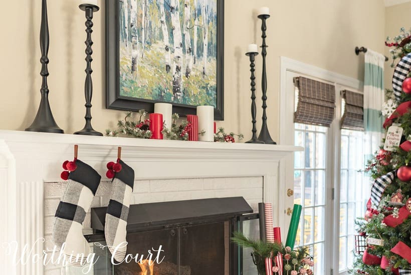 Mantel decorated for Christmas with red, white, green and black.