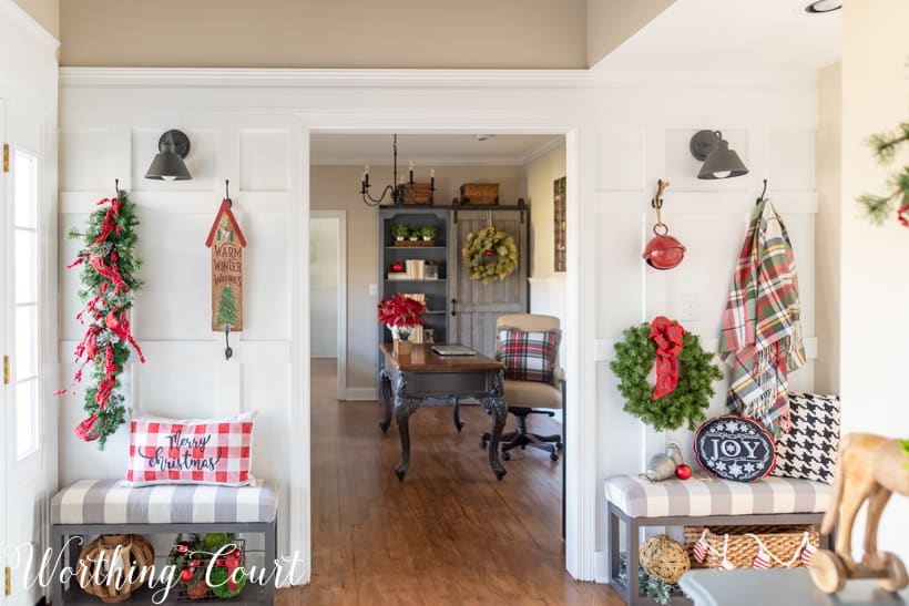 Christmas foyer decorations with plaid and greenery.