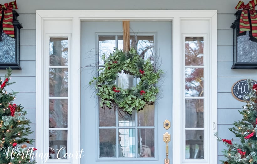 There are bows on the light fixtures on either side of the door.