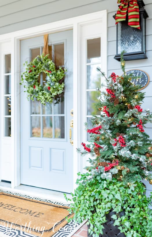 There is a fresh green wreath on the front door.