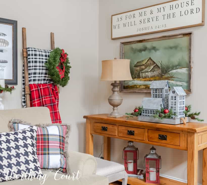 Console table decorated with galvanized houses for Christmas.