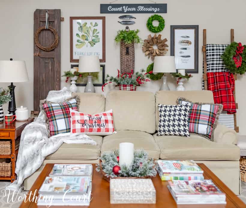 Neutral sofa with plaid Christmas pillows.