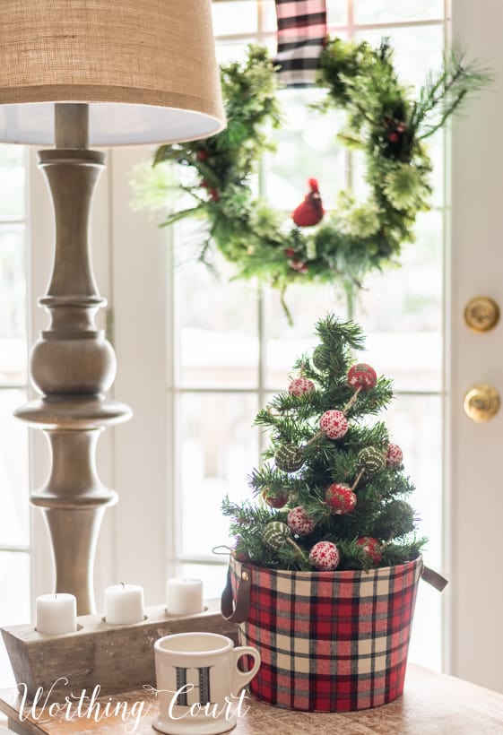 There is a small Christmas tree on the table beside the couch.