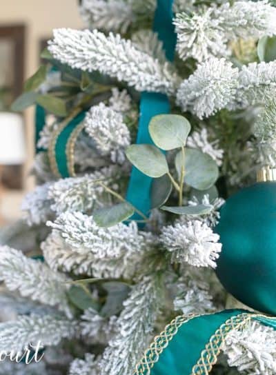 flocked Christmas tree with teal decor