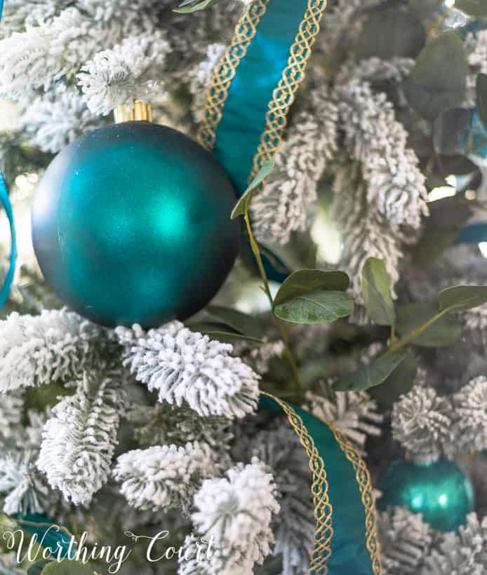 Teal and gold ribbon on the Flocked Christmas tree.