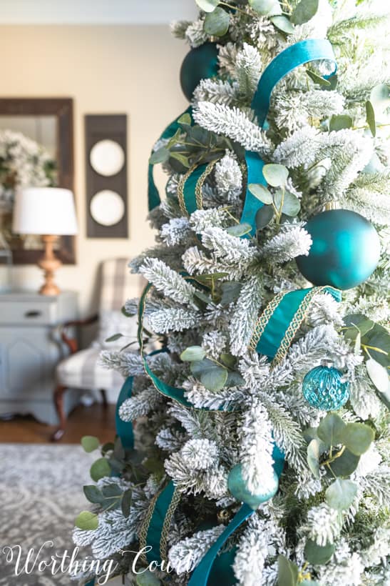 Flocked Christmas tree decorating ideas in the dining room.