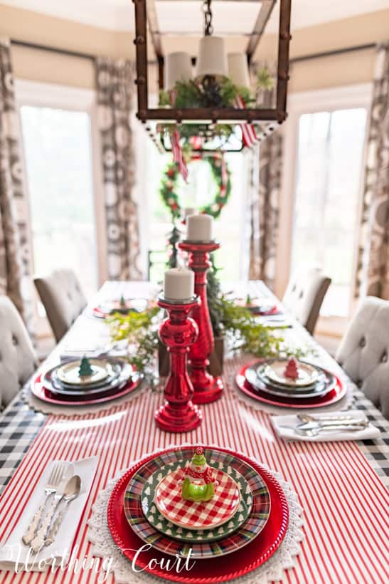 Shiny red candlesticks on the table in the middle.