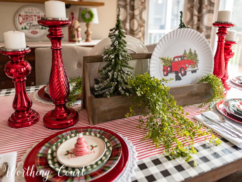 There is a Christmas tree in the wooden box and also fresh greenery.