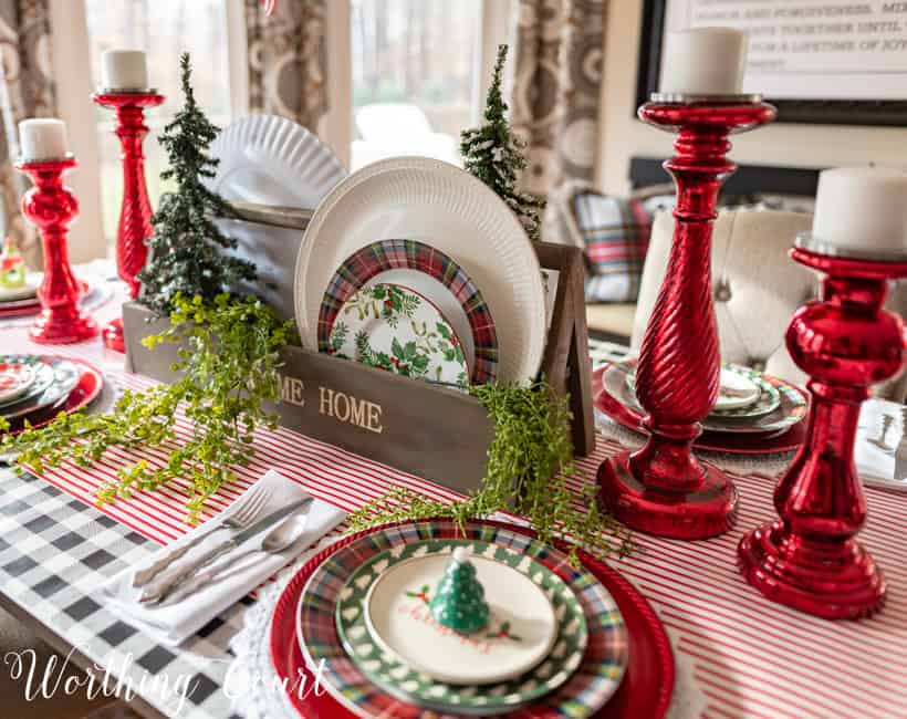 A wooden box filled with Christmas plates.