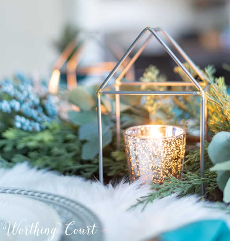 Mercury glass candle votive in a lantern.