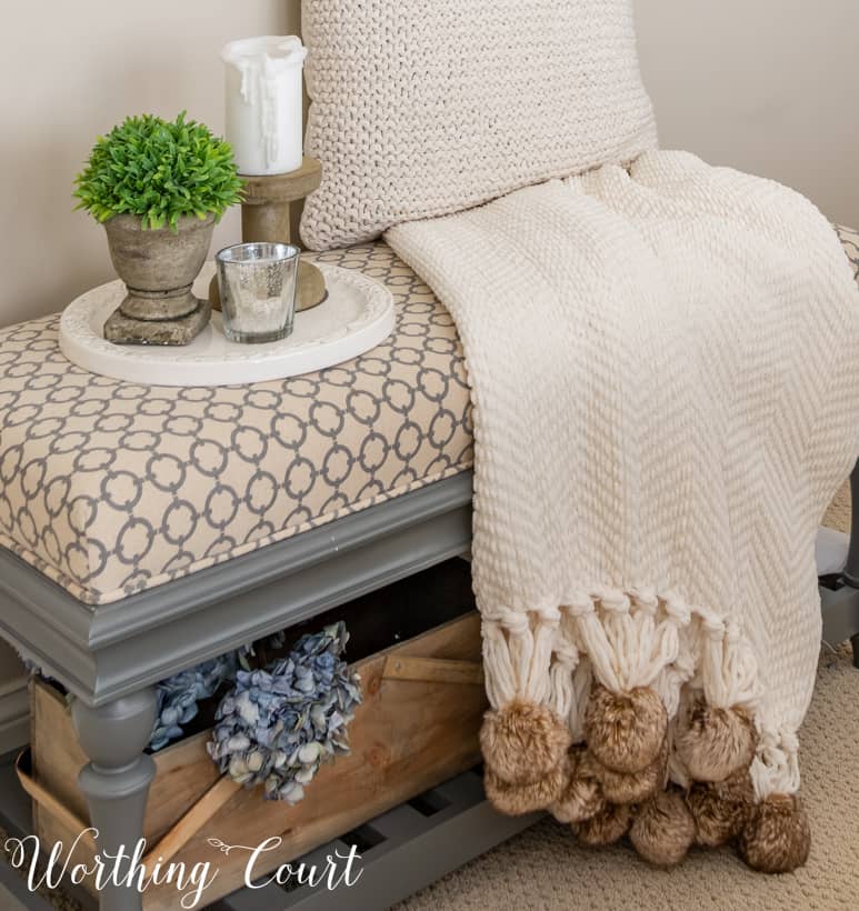 bedroom bench with pompom throw