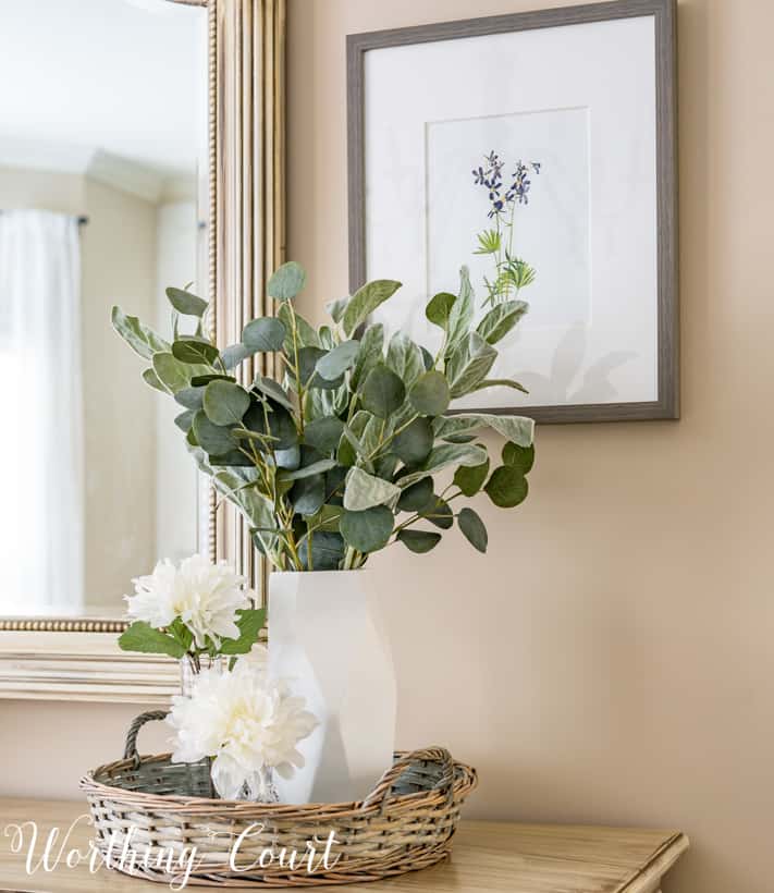 white vases with faux greenery and flowers