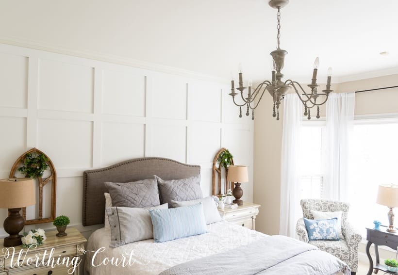 A chandelier hanging above a bed.