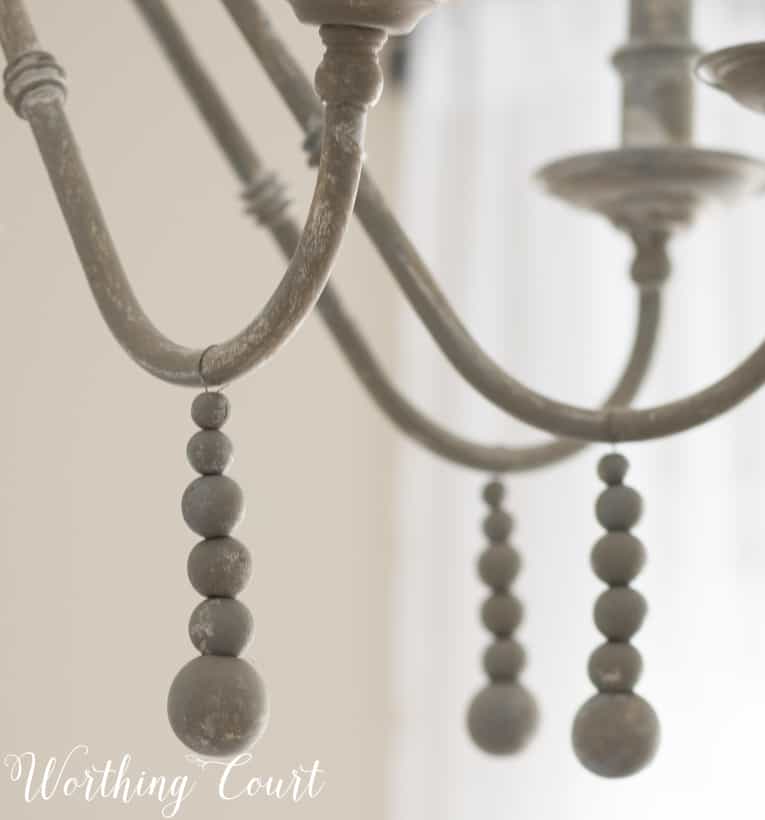 Wooden beads added to a chandelier.