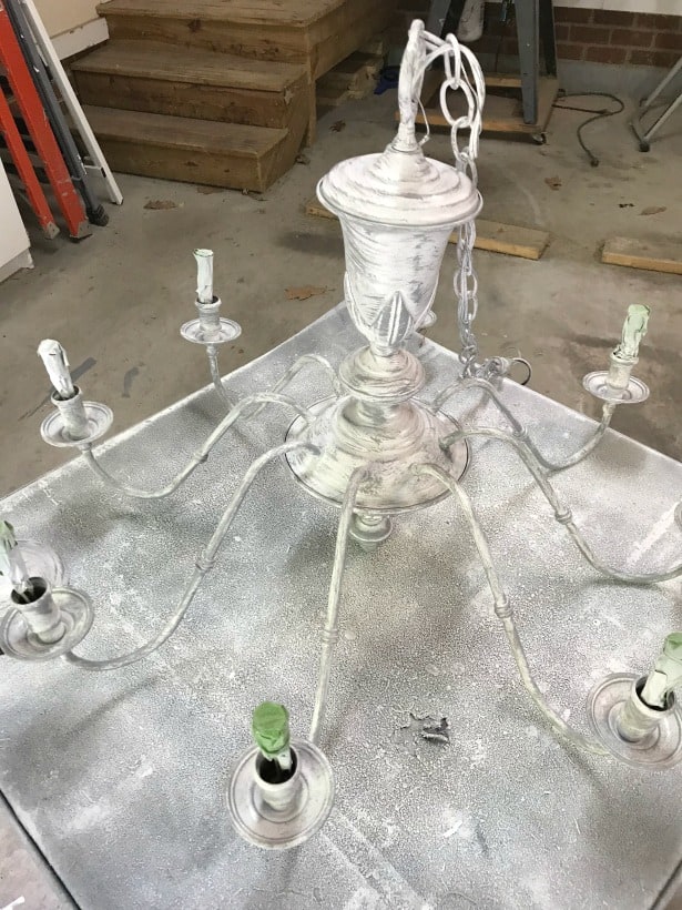 Spraying the chandelier a grey color.