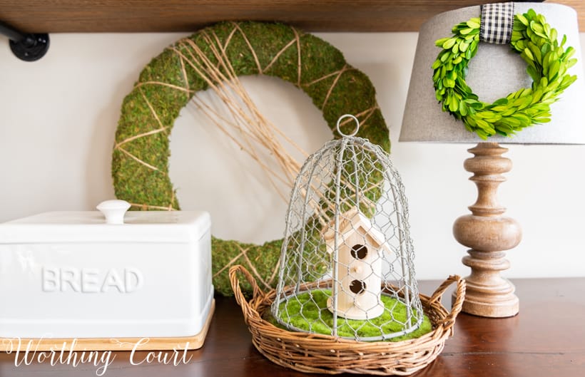 Spring vignette with greenery and natural wood elements.