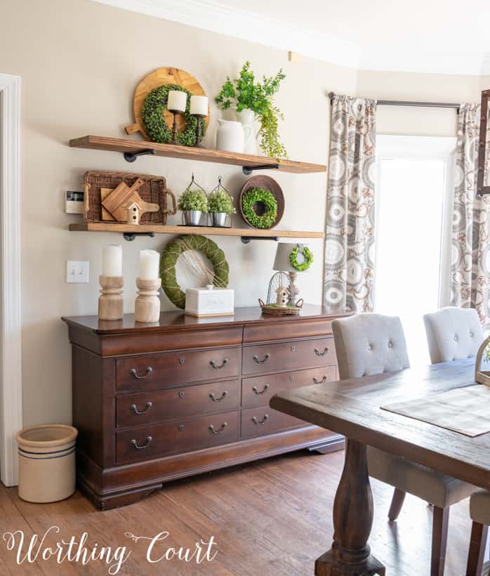 open shelves decorated with greenery, white and wood accessories