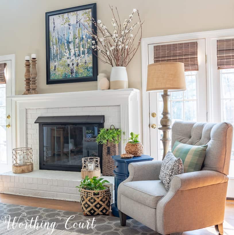 Fireplace brick painted white with candles on the mantle.