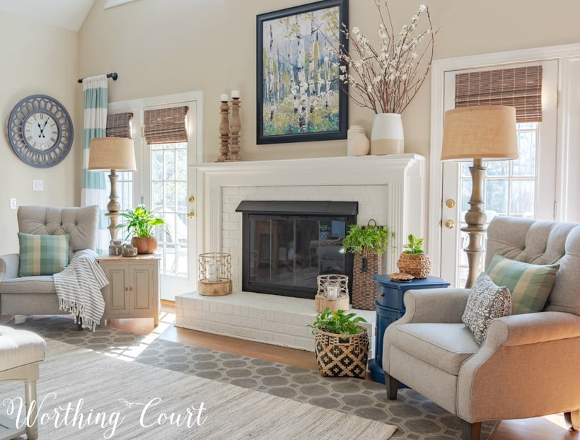 two gray recliners flanking a white brick fireplace