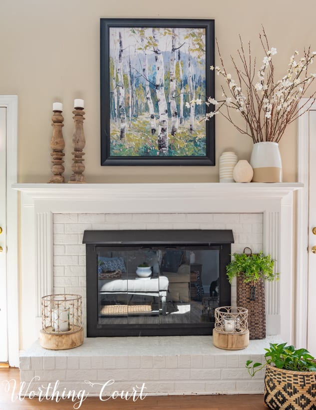 There is a nature picture hanging above the fireplace.
