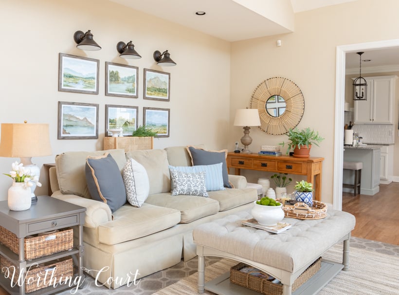 Gallery wall with watercolor prints above sofa.