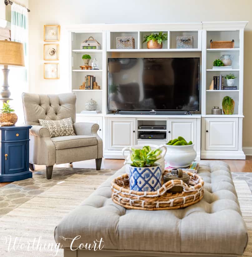 White entertainment center in neutral family room.