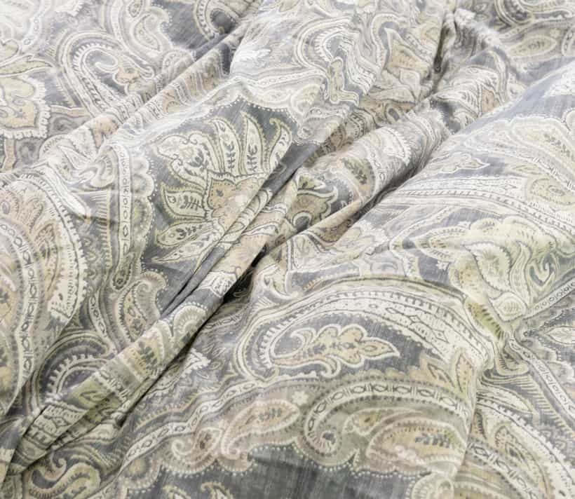 Comforter with gray and off white paisley pattern