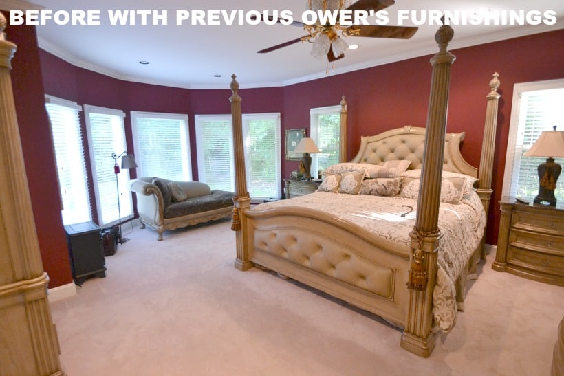 Master bedroom with red walls and a four poster bed.