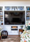 old entertainment center painted white and redecorated with updated traditional and chinoiserie accessories