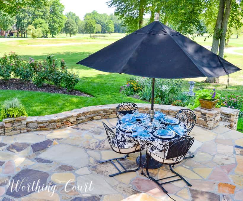 outdoor table with black umbrella on a patio