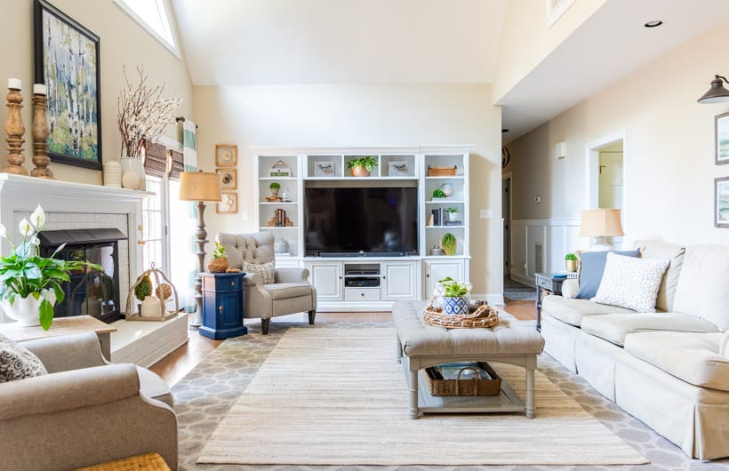 family room with neutral furniture and white entertainment center