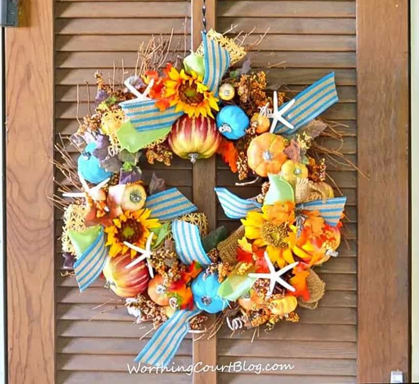 diy fall wreath embellished with pumpkins, sunflowers, starfish and ribbon
