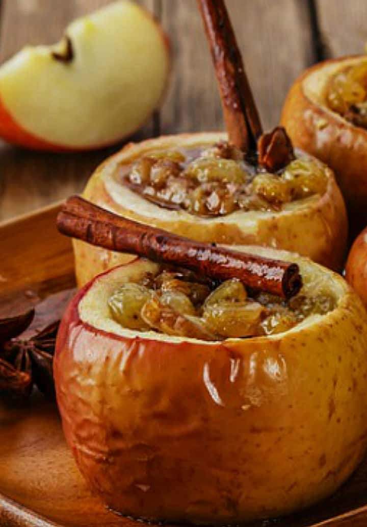 Up close picture of the baked apples with the cinnamon sticks.