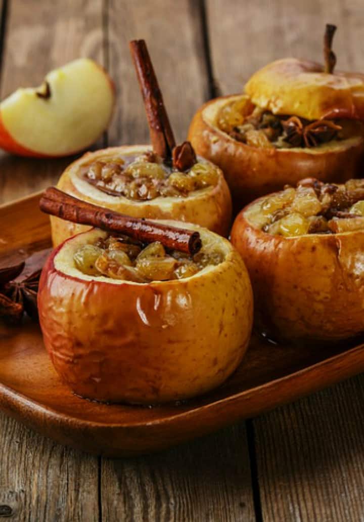 Delicious recipe for baked honeycrisp apples with the baked apples on a wooden platter.