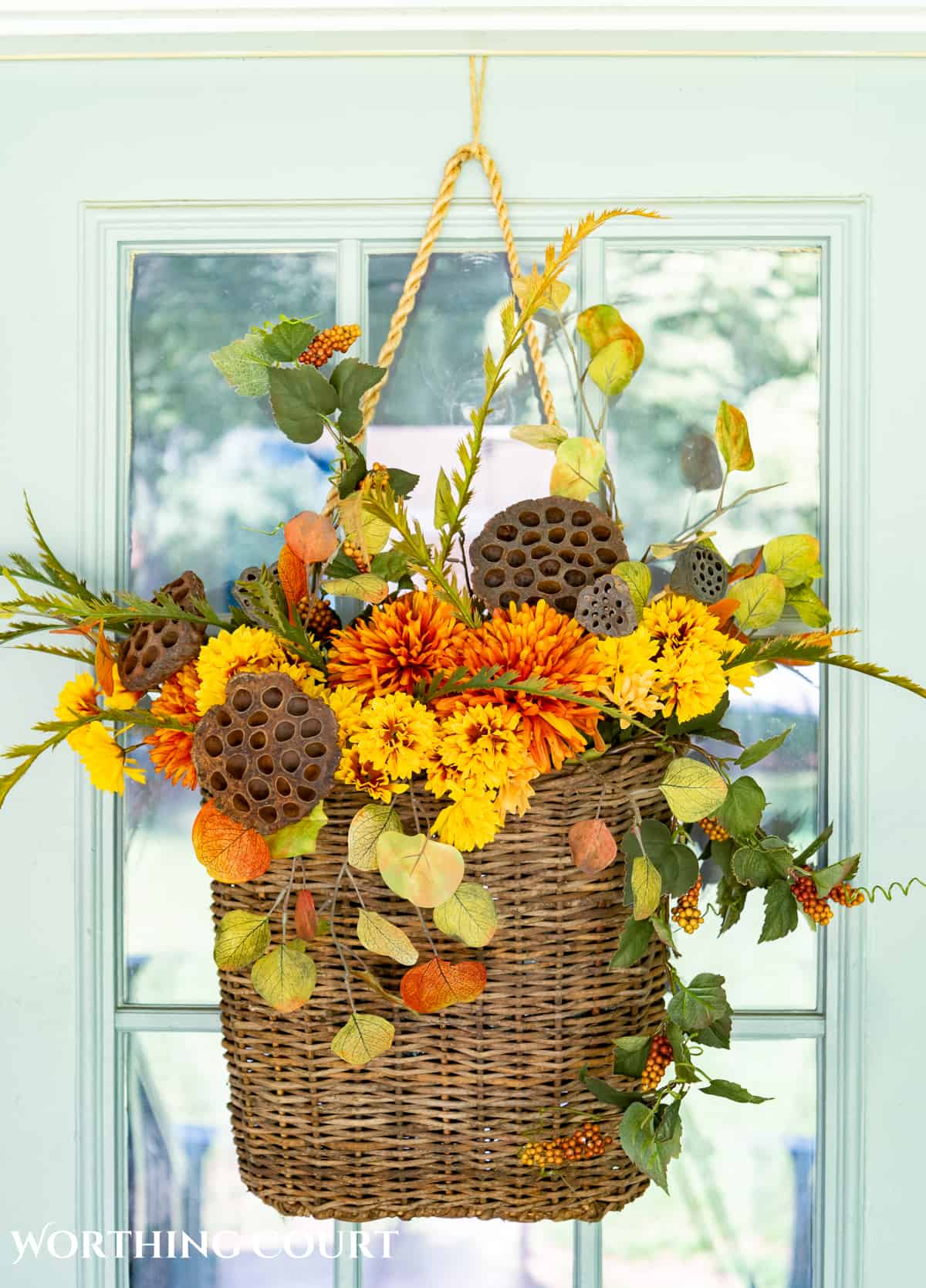 hanging door basket filled with fall foliage